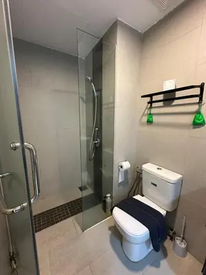 a bathroom with a toilet and a glass shower at Spacious Comfy 8pax, 3 Bedroom, 2 Car Park, The Landmark in Tanjong Tokong