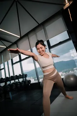 a woman standing in a gym with her arms outstretched at 22 Macalisterz George Town By Mana-Mana in George Town