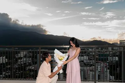 a man and a woman standing on a balcony at 22 Macalisterz George Town By Mana-Mana in George Town