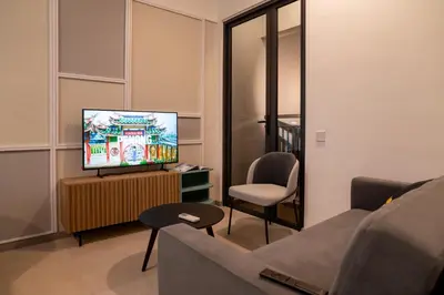 a living room with a couch and a television at 22 Macalisterz Leisure Suites George Town in George Town