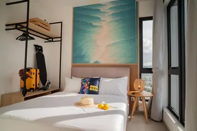 a bedroom with a bed with a hat on it at 22 Macalisterz Leisure Suites George Town in George Town