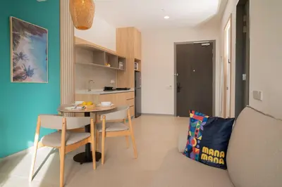 a living room with a table and chairs in a room at 22 Macalisterz Leisure Suites George Town in George Town