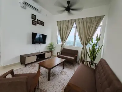 a living room with a couch and a table at Aplan Falim by Irainbow in Ipoh