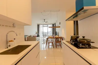 a kitchen with a sink and a stove top oven at Beacon Executive Service Suite Penang in George Town