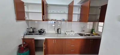 a small kitchen with wooden cabinets and a sink at A357 Silverpark Resort Best Mountain view in Bukit Fraser