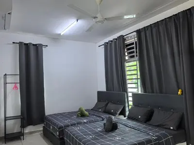 a bedroom with two beds and a window at Padang Serai Wangi Homestay 402 in Padang Serai