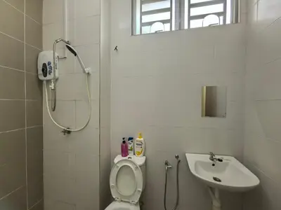 a bathroom with a shower and a toilet and a sink at Padang Serai Wangi Homestay 402 in Padang Serai