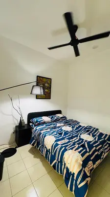 a bedroom with a bed and a ceiling fan at 122 SEGARi in Lumut