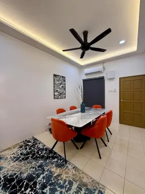 a dining room with a table and chairs and a ceiling fan at 122 SEGARi in Lumut