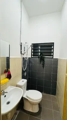 a bathroom with a toilet and a sink at 122 SEGARi in Lumut