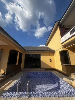 a swimming pool in the courtyard of a house at MY LENA Villa in Baling