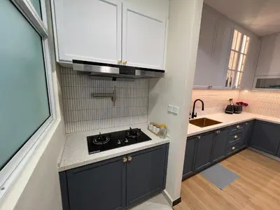 a kitchen with white cabinets and a black stove top oven at Master Bedroom only in Bayan Lepas Share Space in Bayan Lepas