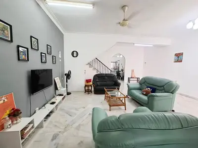 a living room with two green chairs and a tv at Acacia Guesthouse by ZamanJa in Ipoh