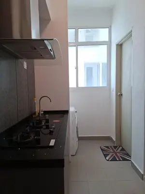 a kitchen with a black counter top and a window at Cozy Homestay - Ipoh Garden in Ipoh