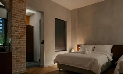 a bedroom with a large bed and a window at Bishop House in George Town
