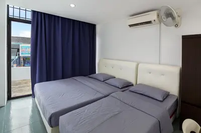 two beds in a room with blue curtains at Mingle 7 Hostel Georgetown Penang in George Town