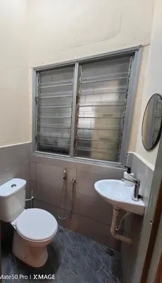 a bathroom with a toilet and a sink at TL Legend Homestay2 - 4 bedroom single story house in Ipoh