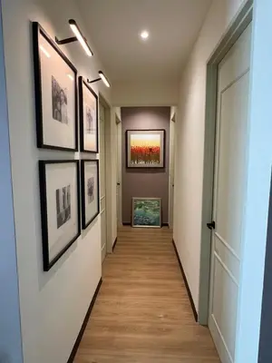 a hallway with framed pictures on the walls and a hallway with a hallway at Middle Room Only in Bayan Lepas Share Space in Bayan Lepas