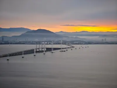 a bridge over a large body of water at sunset at Middle Room Only in Bayan Lepas Share Space in Bayan Lepas