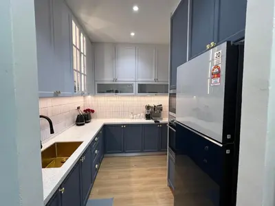a kitchen with blue cabinets and a refrigerator at Middle Room Only in Bayan Lepas Share Space in Bayan Lepas