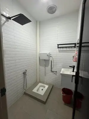a bathroom with a toilet and a sink at Family friendly flower homestay-3bedroom in Gerik