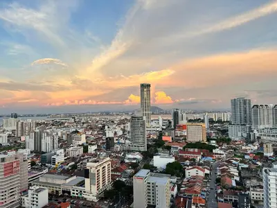 a city skyline with buildings and a cloudy sky at Cozy studio with Komtar view at 22 Macalisterz in George Town