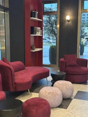 a living room with red chairs and ottomans at Cozy studio with Komtar view at 22 Macalisterz in George Town