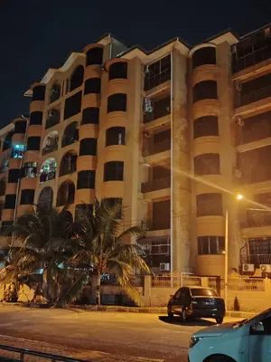 a car parked in front of a building at night at Ed 03 lumut Waterfront in Lumut