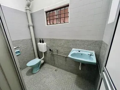 a bathroom with a blue toilet and a sink at Inap by KF in Bayan Lepas