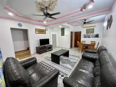 a living room with a leather couch and a table at Inap by KF in Bayan Lepas