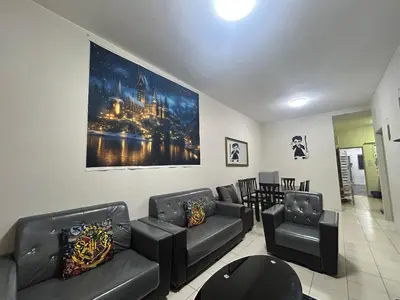 a living room with couches and a painting on the wall at Harry Potter Homestay Cameron Highlands in Tanah Rata