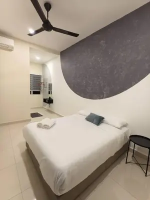 a bedroom with a white bed and a ceiling fan at Hello Pangkor Home 73A - A Nest for 12 buddies in Pangkor