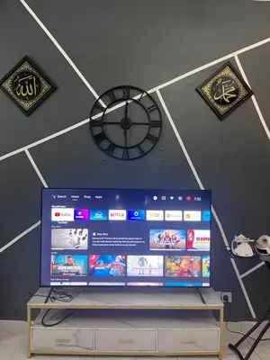 a clock on the wall and a tv in a room at Dheaa's Homestay Cameron Highlands in Tanah Rata