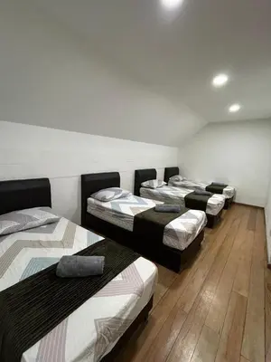 a group of four beds in a room at Ereens guest house Cameron highland in Brinchang
