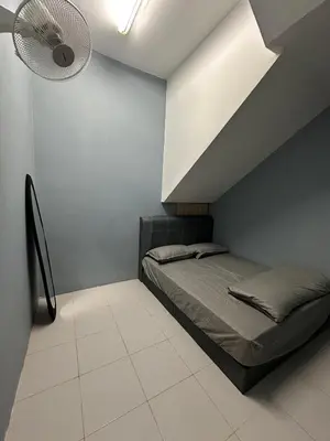 a bedroom with a bed and a ceiling fan at Shamrock By Island Hospitality in Batu Ferringhi