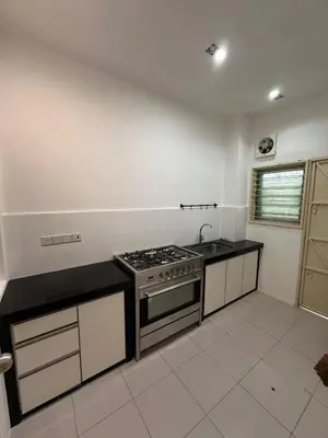 a kitchen with a stove and a sink at Shamrock By Island Hospitality in Batu Ferringhi