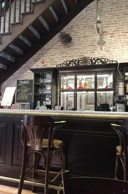 a bar in a restaurant with two chairs and a counter at You Le Yuen in George Town
