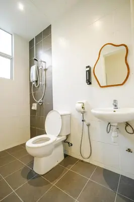a bathroom with a toilet and a sink at Comfy Sofy-Bunny Vintage Penthouse in Tanah Rata