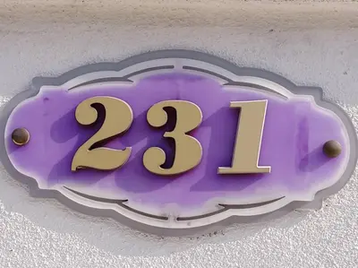 a purple sign with the on a wall at Sekinchan 231 VA Chalet in Sekincan