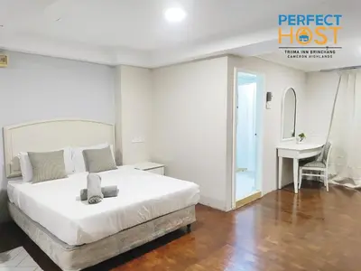 a white bedroom with a bed and a desk at Triima Inn Brinchang by Perfect Host in Brinchang