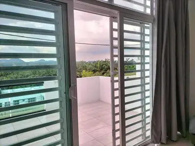 a glass door leading to a balcony with a view at Cozy 4 bedrooms Double Storey Homestay, in front Kulim Central Mall in Kulim