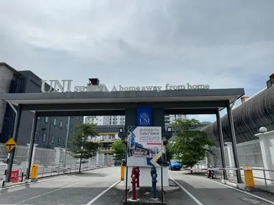 a bridge over a street with a sign on it at The Cozy Loft in Kampar
