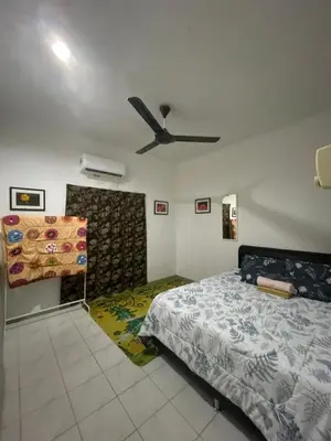 a bedroom with a bed and a ceiling fan at GerchangLakeHouse in Behrang Hulu