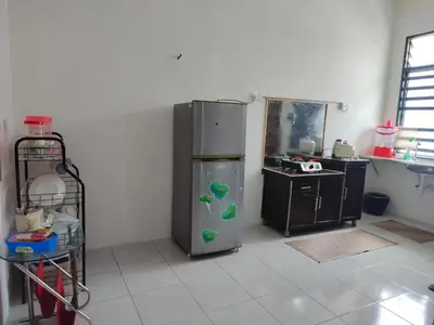a kitchen with a refrigerator with green balls on it at Myrol Homestay Padang Serai Kulim in Padang Serai