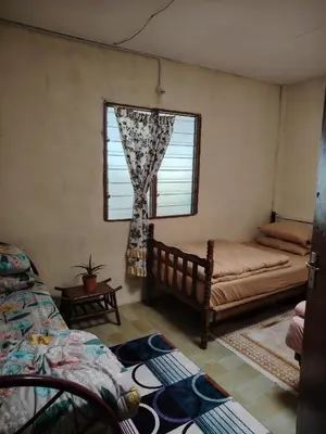 a bedroom with two beds and a window at Fantasy Stay Cameron Highlands in Kampung Kuala Terla