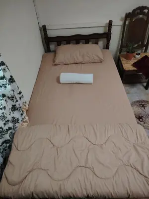 a bed with a towel on top of it at Fantasy Stay Cameron Highlands in Kampung Kuala Terla