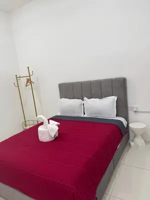 a bed with a red blanket and a swan on it at Ramadhina The Luxe Retreat Home2stay Ipoh in Ipoh