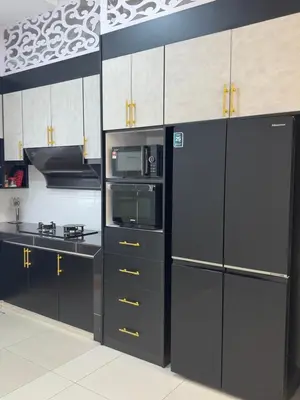 a kitchen with black cabinets and a black refrigerator at Ramadhina The Luxe Retreat Home2stay Ipoh in Ipoh