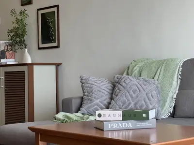 a living room with a table with a pizza box on it at Moriash Stay in Brinchang
