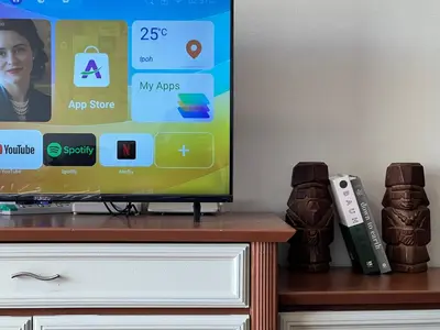 a tv screen with a video game console and a remote control at Moriash Stay in Brinchang